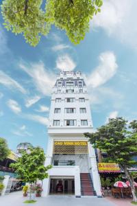 a white building with a sign on the side of it at Cao Minh Hotel in Lao Cai