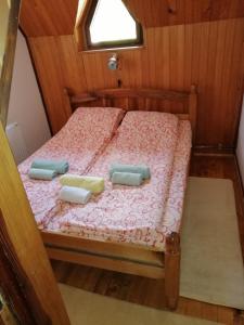 a bed with two pillows on it in a room at Apartment Skulova Vodenica in Mokra Gora