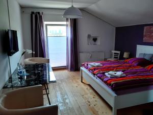 a bedroom with a bed and a glass table at Florentiner Haus in Kiefersfelden