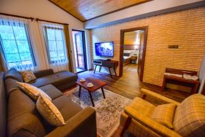 a living room with a couch and a tv at VADİ UZUNGÖL in Uzungol