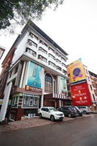 a white car parked in front of a building at Hotel Mangalore International in Mangalore