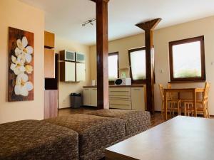 a living room with two beds and a kitchen at Ubytovanie Žaneta in Krásnohorské Podhradie