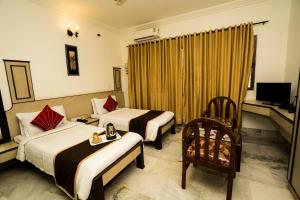 A bed or beds in a room at Hotel Mangalore International
