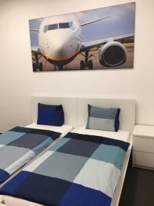 a bed room with two airplanes and a painting on the wall at AeroRooms in Prague