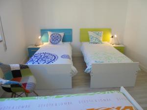 a room with two beds and a table at Jaen Apartment in Ponferrada