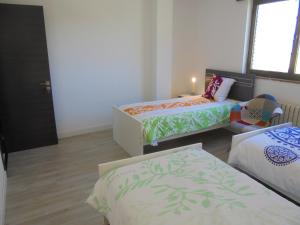 a small room with a bed and a desk at Jaen Apartment in Ponferrada