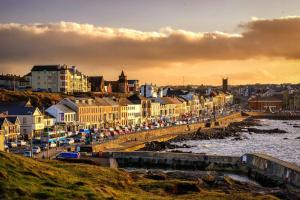 a view of a city with a pier and buildings at The Promenade, Portstewart in Portstewart