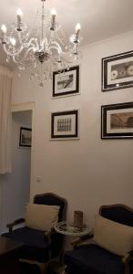 a living room with two chairs and a chandelier at Lisbon Downtown Inn in Lisbon