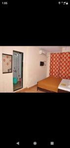a small bedroom with a bed and a window at Relax inn in Matheran