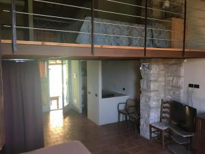 a room with a bunk bed and a living room at I Casali del Trebbiolo in Molino del Piano