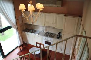 a kitchen with white cabinets and a stove at Tenuta i Massini in Empoli