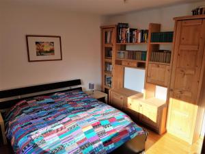 a bedroom with a bed and a book shelf at Ferienwohnung mit eigenem Pool und finnischer Sauna in Witten in Witten +31 photos