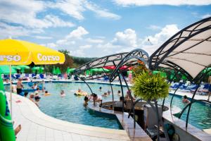 a group of people in a pool at a water park at Pensiunea Duet in Sărata-Monteoru