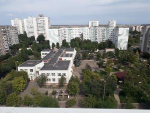 a large white building in a city with tall buildings at apart-hotel Sky in Yuzhne