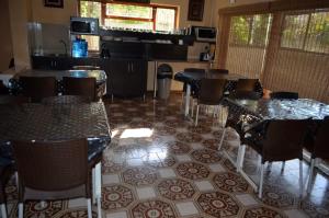 a dining room with tables and chairs on a tiled floor at ST@Y-1-BnB in Cape Town