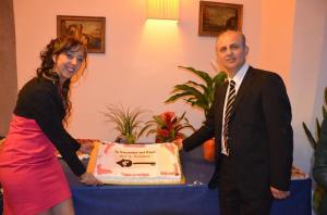 a man and a woman holding a cake at Locanda dei Fiori in Pistoia