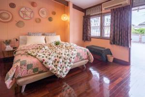 a bedroom with a bed in a room at Dunah's Garden Home in Bangkok