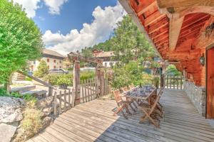 a wooden deck with a table and chairs on it at CHALET L'GORZON in Morzine