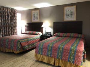 Postel nebo postele na pokoji v ubytování Sun Coast Inn