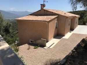 a small house with a view of a mountain at ELI&LOU avec piscine et voiture in Alata