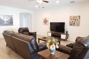a living room with leather furniture and a flat screen tv at G7009-New House Disney-Universal Studios in Davenport