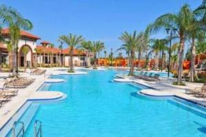 a large swimming pool with chairs and palm trees at G7009-New House Disney-Universal Studios in Davenport