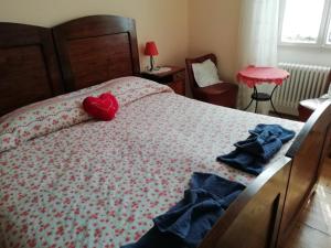 a bedroom with a bed with a red heart on it at Agritur Tenno Bio Natura in Tenno