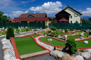 a garden in front of a building with a house at Vila Horal in Liptovský Mikuláš