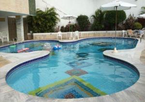 a large swimming pool in a hotel at Flat Apart Hotel Ondina Barra em Salvador in Salvador