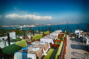a row of tables and chairs with a view of the ocean at Mytra Hotel in Istanbul