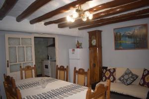 a living room with a table and a couch and a kitchen at Casa Larrosa rural en Sierra de Guara in Sieso de Huesca