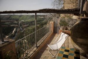 a balcony with two chairs and a table and a view at La Casa Grande in Arcos de la Frontera