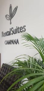 um sinal para o aluguer de suites campana com uma planta em RENTAL SUITES CAMPANA em Campana
