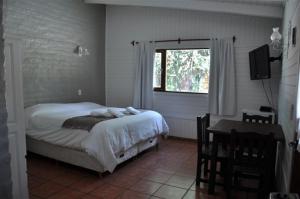 Ένα ή περισσότερα κρεβάτια σε δωμάτιο στο Cabañas y Hosteria Aldea Los Huemules