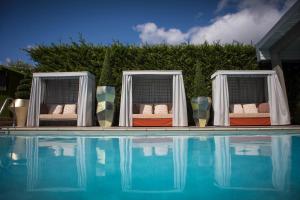 two large swimming pools are shown in the sunlight at Homewood Hotel & Spa in Bath