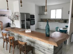 a kitchen with a wooden counter with a vase on it at ELI&LOU avec piscine et voiture in Alata