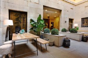 a patio with a table and chairs and plants at Catalonia Puerta del Sol in Madrid