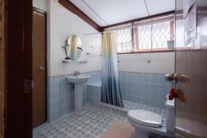 a bathroom with a toilet and a sink at Dunah's Garden Home in Bangkok +28 photos
