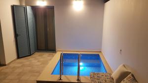 a swimming pool in the middle of a room at Tanyas Cozy House in Kamilari
