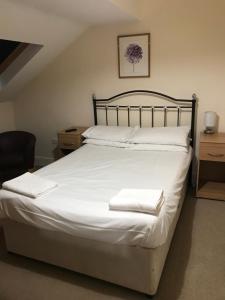 a bedroom with a bed with two white towels on it at Pay2Stay in Chester