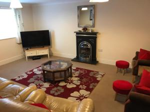 a living room with a couch and a fireplace at Pay2Stay in Chester