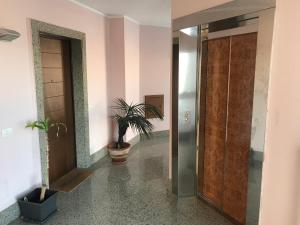 a hallway with a door and a potted plant at MaMà Suite in Lecce