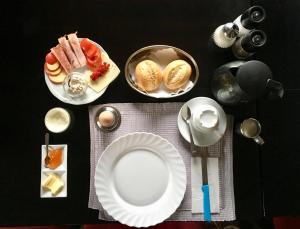 a table with plates of food on a table at Pension Akropolis in Rellingen