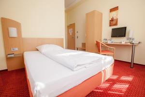 Postel nebo postele na pokoji v ubytování Johanniterhotel