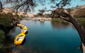 a yellow and blue boat floating on top of a body of water at Anakato Nubian Experience in Aswan