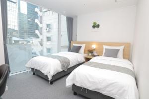 Rúm í herbergi á Line Hotel Myeongdong