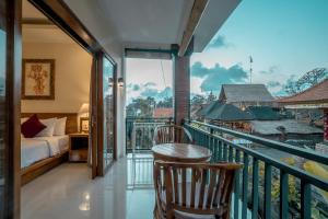 Pokój z balkonem z łóżkiem i sypialnią w obiekcie Sriwedari 40 Ubud w mieście Ubud