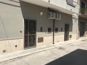 a building with doors on the side of a street at La Maison Doppia in Stornara