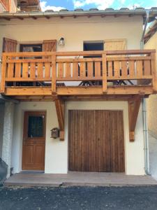 a wooden deck on the side of a house at maison colmars in Colmars