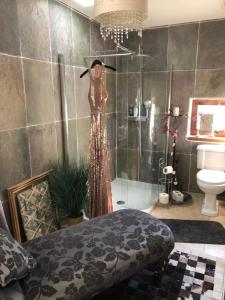 a dress on a mannequin in a bathroom at Belmont House Boutique - the Kingsley collection in Berwick-Upon-Tweed